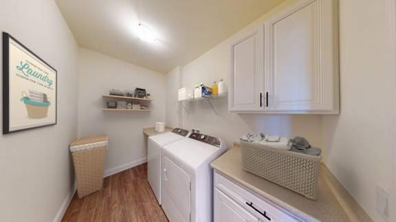 A small laundry room with a washer and dryer.