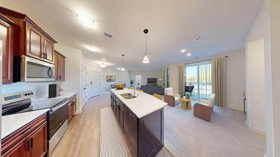 A modern kitchen with wooden cabinets and a large island.