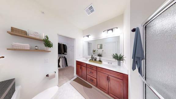 A bathroom with a white sink and a mirror above it.