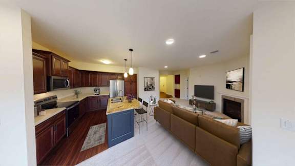 A modern kitchen with dark wood cabinets and a blue island.