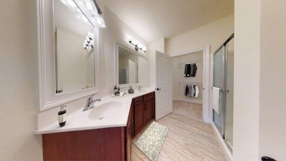A bathroom with a sink, mirror, and a rug.