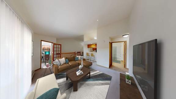 A living room with a brown couch and a television.