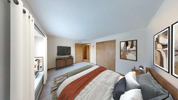 A bedroom with a bed, a television, and a painting on the wall.