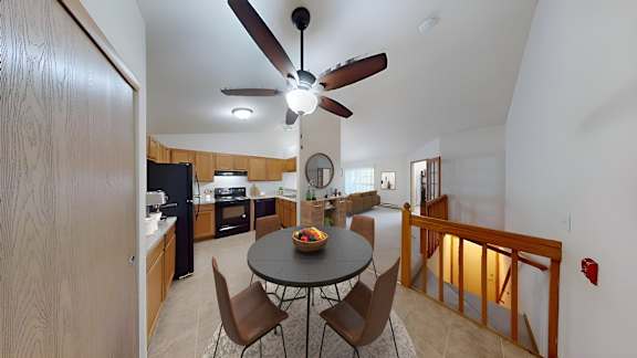 A kitchen with a table and chairs in the middle of the room.