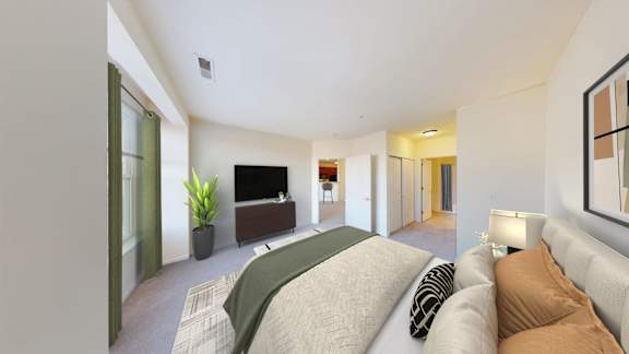 A living room with a couch, a television, and a plant.