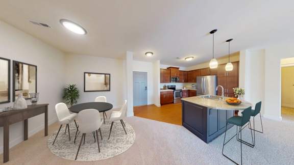 A modern kitchen with a dining table and chairs in the middle of the room.