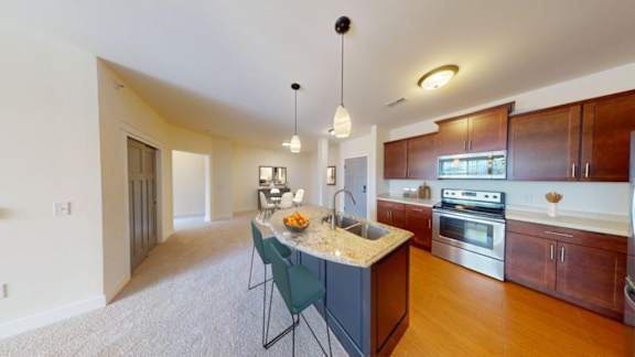 A kitchen with a table and chairs in the middle of it.