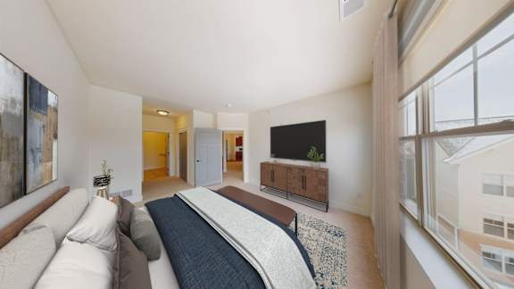 A living room with a couch, a rug, and a television.