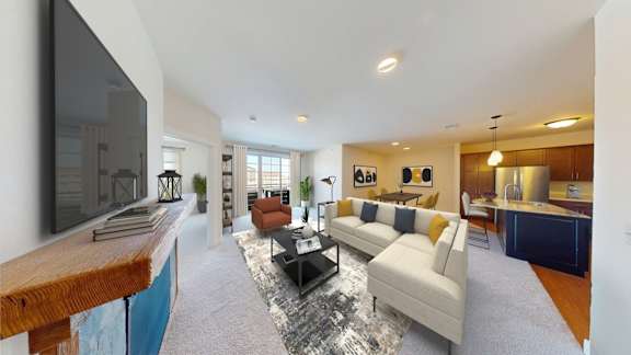 A modern living room with a television on the left side and a sofa set in the center.