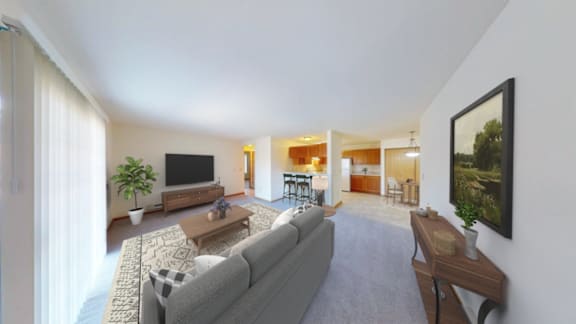 A living room with a grey couch and a television.