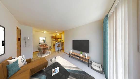 A living room with a brown couch and a flat screen TV.