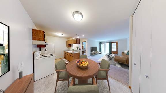 A modern kitchen with a dining table and chairs.