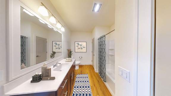 A bathroom with a white counter and a mirror above it.