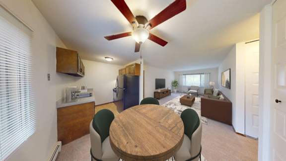 A dining room with a wooden table and chairs.