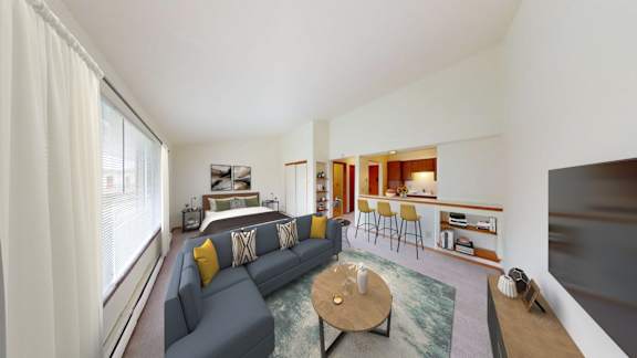 A living room with a grey couch and a coffee table.