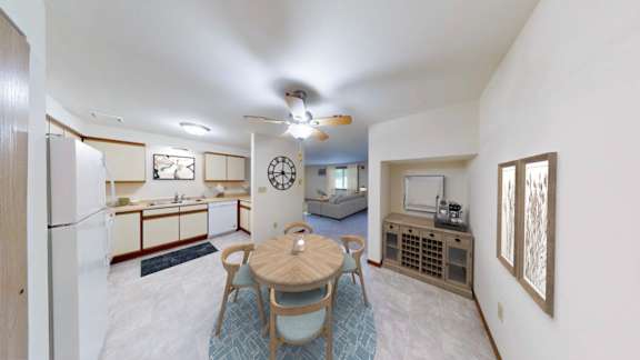 A living room with a dining table and chairs.