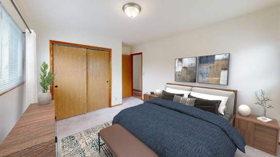 A bedroom with a bed, nightstand, and a plant.