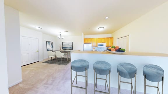 a kitchen with a counter and three bar stools