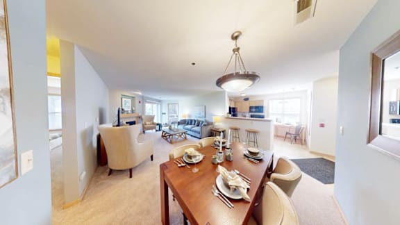 A dining room with a wooden table set for a meal.