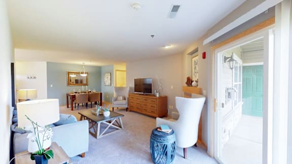 A living room with a white couch and a coffee table.