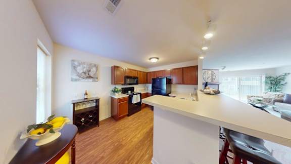 A kitchen with wooden floors and white walls.