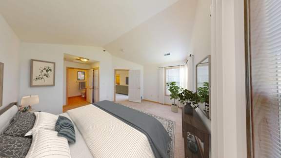 A bedroom with a large bed and a painting on the wall.