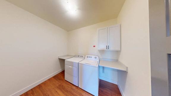 A small laundry room with a washer and dryer.