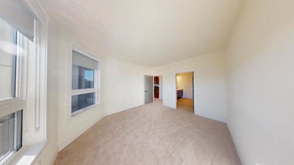 A room with a carpeted floor and white walls.
