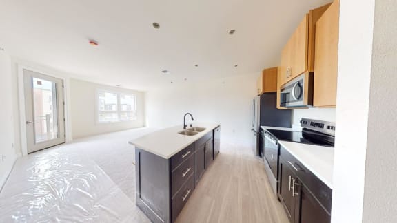 a kitchen with a sink and a stove and a refrigerator