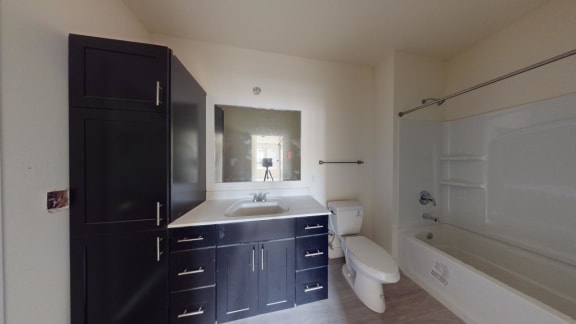 a bathroom with a sink toilet and a bath tub