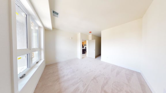 a empty room with a large window and white walls