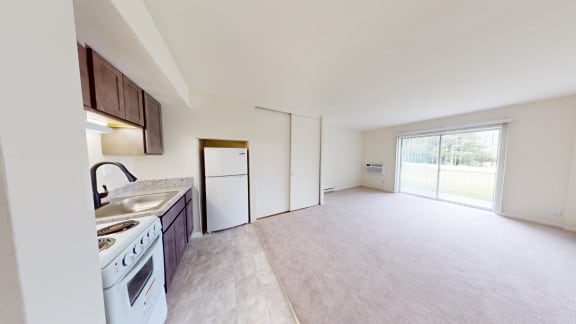 an empty kitchen with a stove and a refrigerator