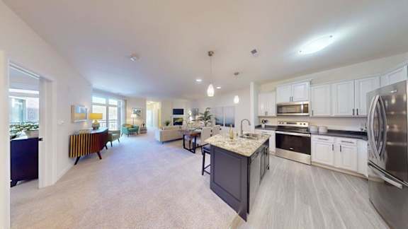 A spacious kitchen with a large island and stainless steel appliances.