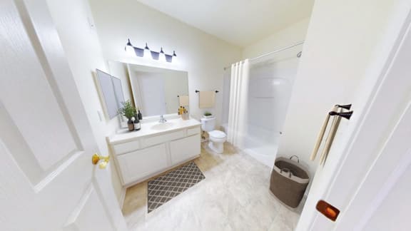 a white bathroom with a sink and a toilet
