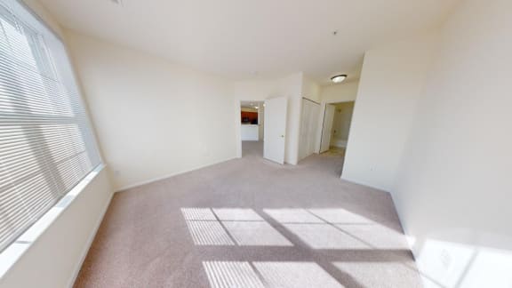 the living room and dining room of an empty home with a large window