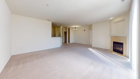 an empty living room with a fireplace