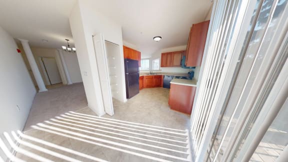 a view of a kitchen and a living room from a staircase