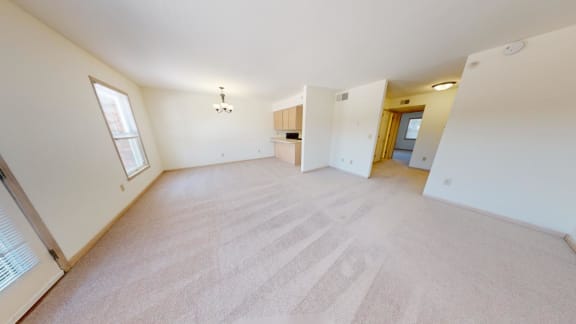 an empty living room and kitchen in a home