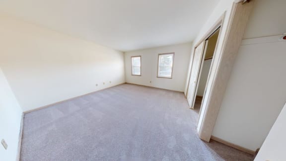 a room with a carpeted floor and white walls