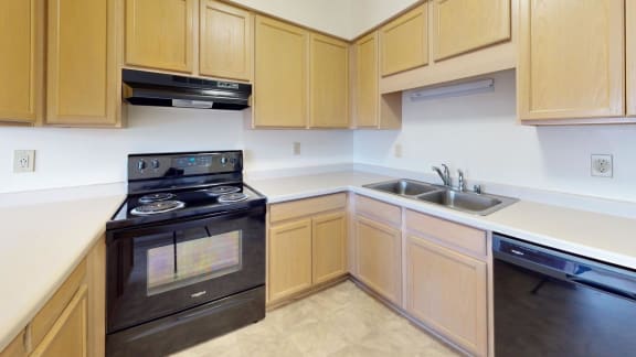 a kitchen with black appliances and wooden cabinets
