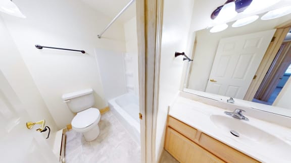 a bathroom with a toilet and a sink and a tub