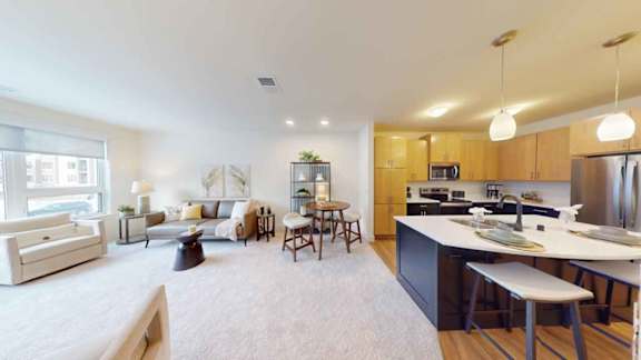 A modern kitchen with a dining table and chairs is visible.