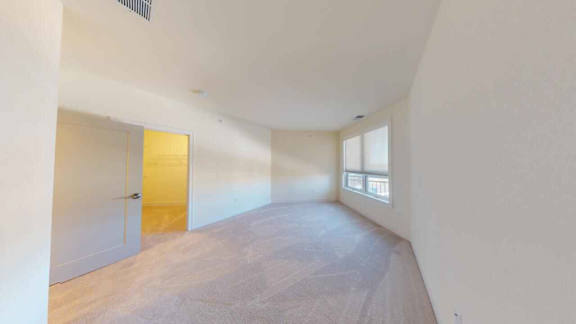 A room with a wooden door and a window.
