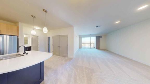 A spacious kitchen with a countertop and cabinets.
