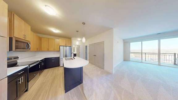 A spacious kitchen with wooden cabinets and a large island.