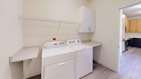 A white washing machine and dryer in a laundry room.