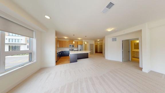 A large, empty room with a window on the left side.