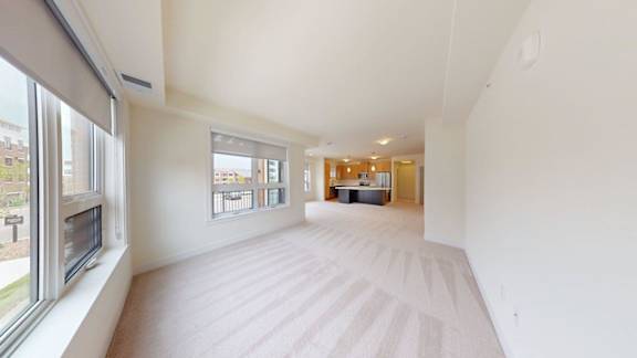 A large, empty room with a window on the left side.