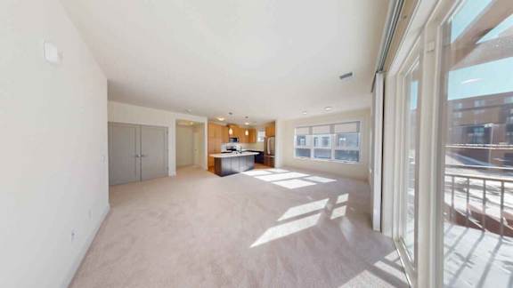 A spacious room with a large window on the right side.