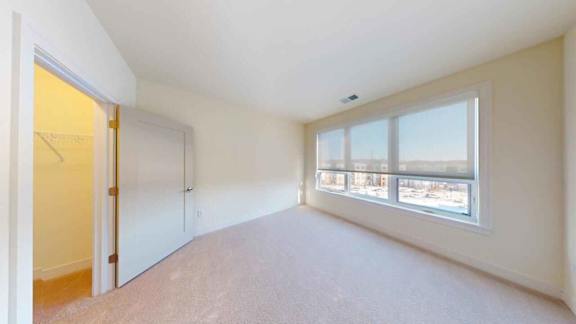 A room with a large window and a door.